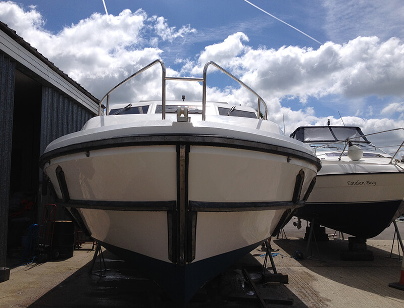 front of white boat after repair