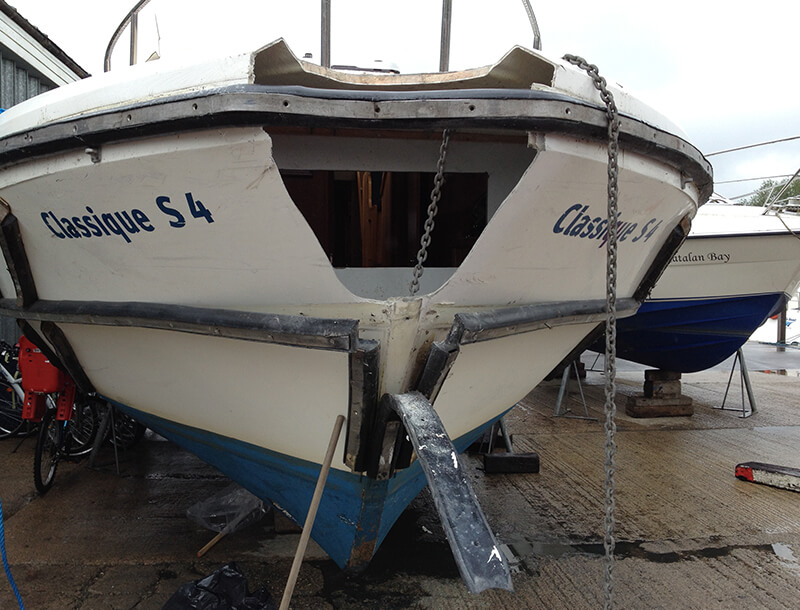 front of white boat before repair